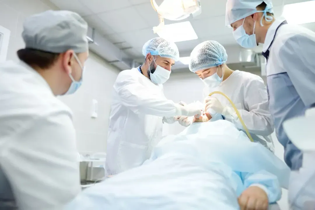 Surgical team performing dental procedure on patient in operating room